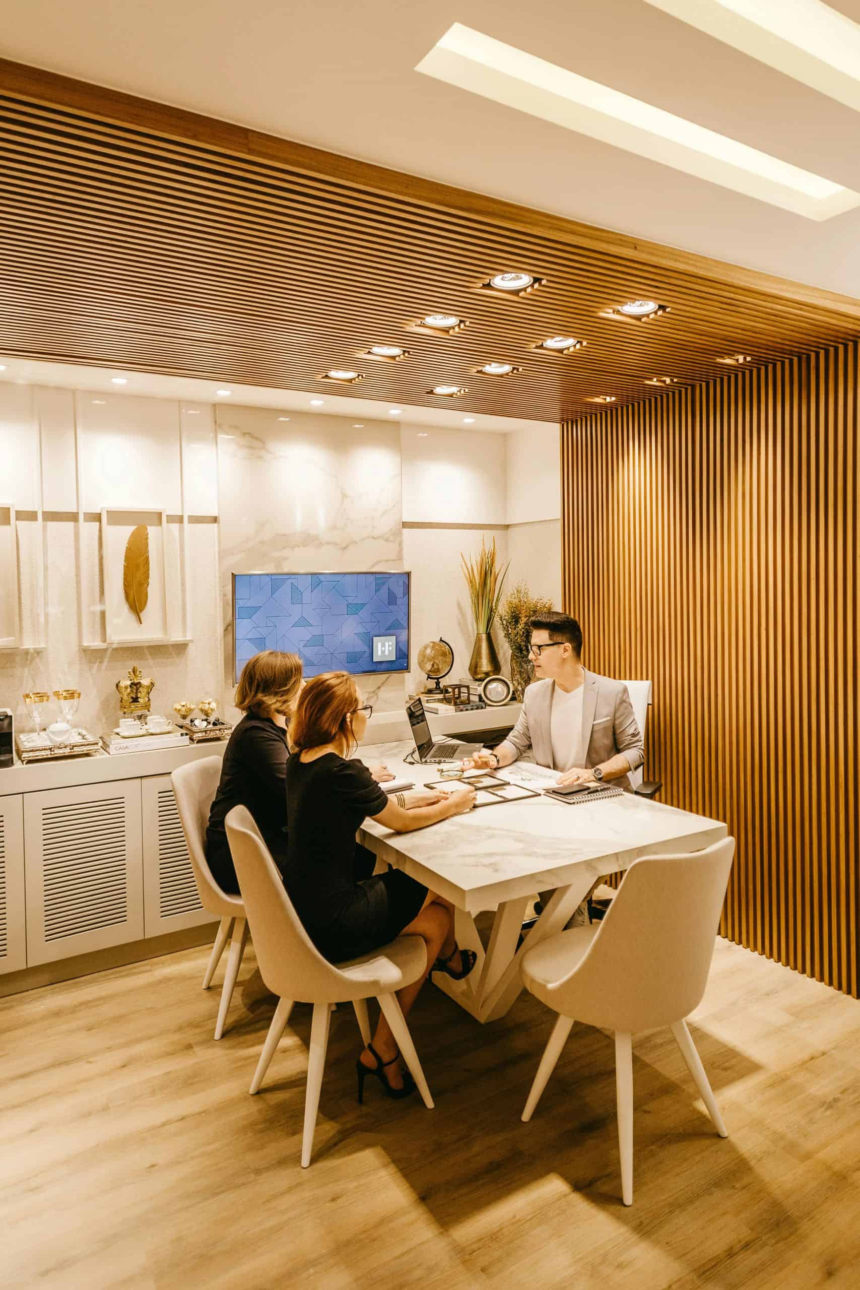 A diverse management team collaborating on architectural sketches and digital data for a large-scale infrastructure project.