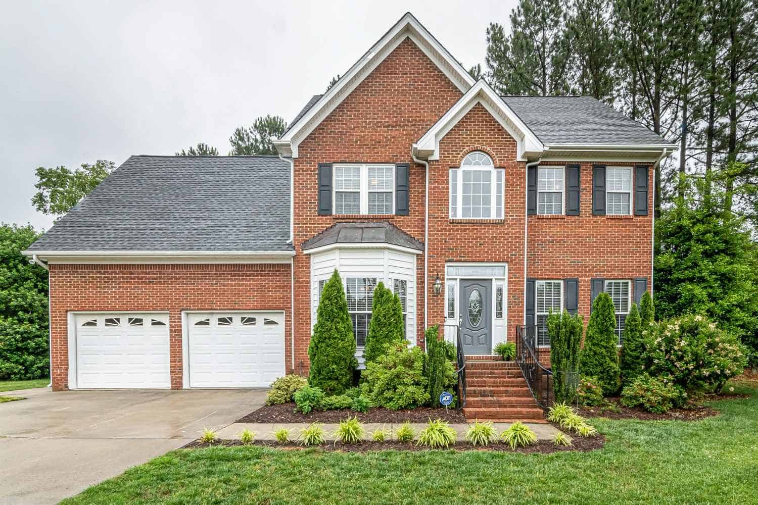 Brick suburban home with manicured landscaping representing professional HOA management services in Salem, Oregon.